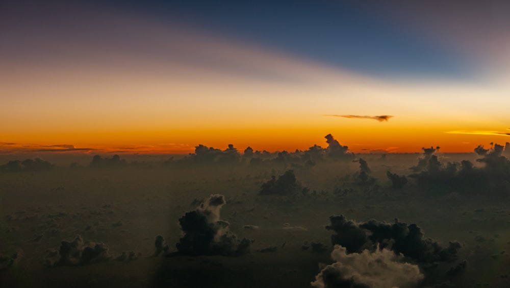 white and black clouds on the air under golden hour