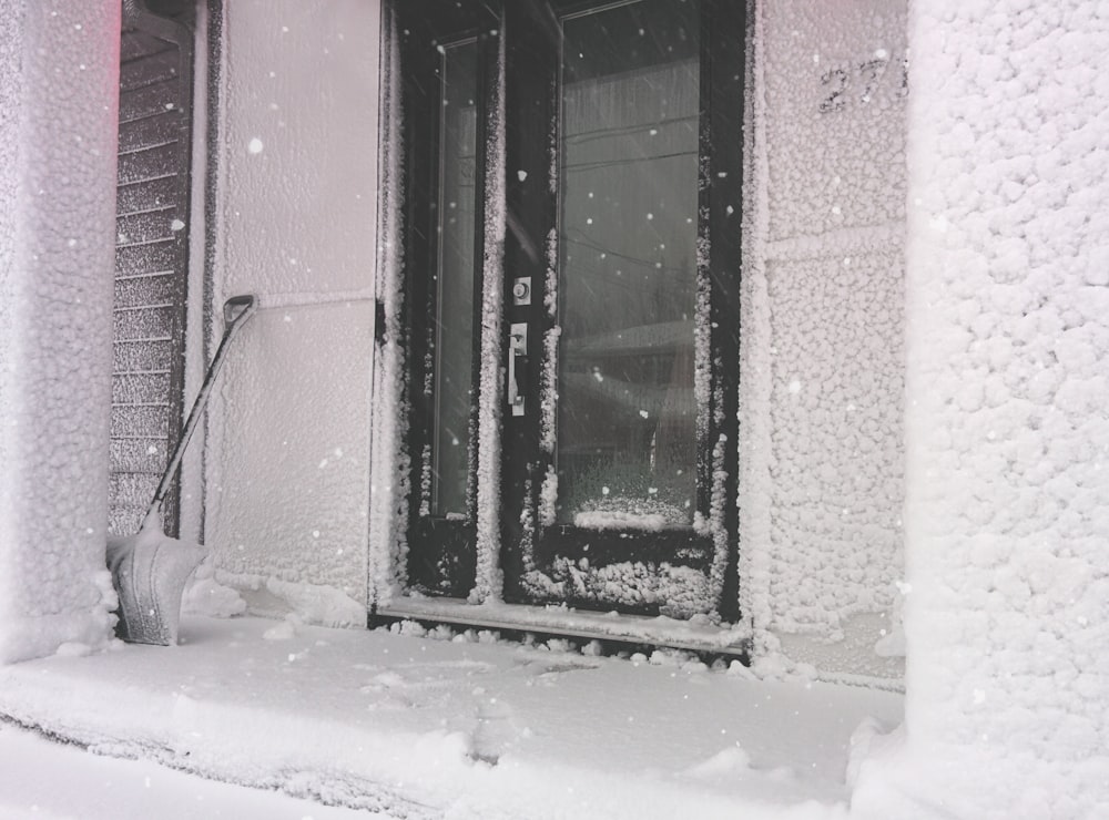 a snow covered front door of a building