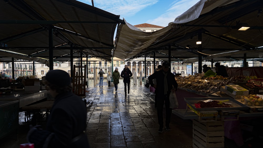 silhouette of walking people under canopy during daytime