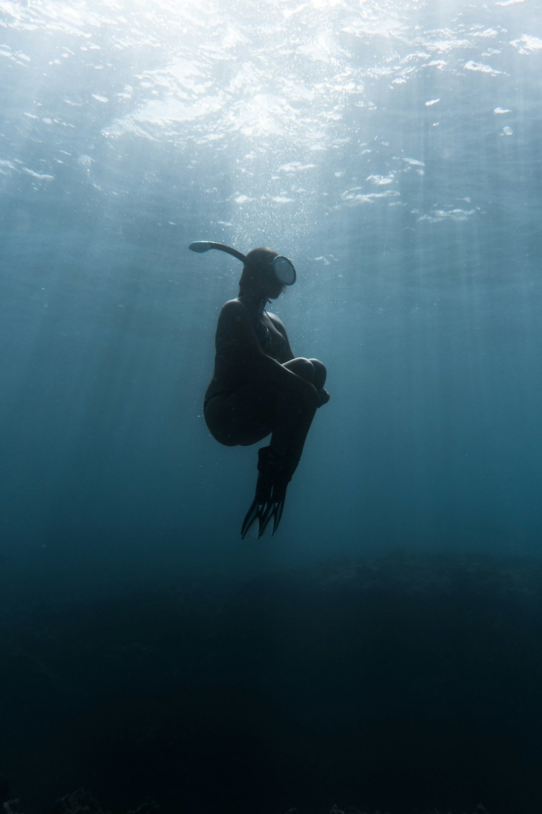 woman with snorkle floating in water