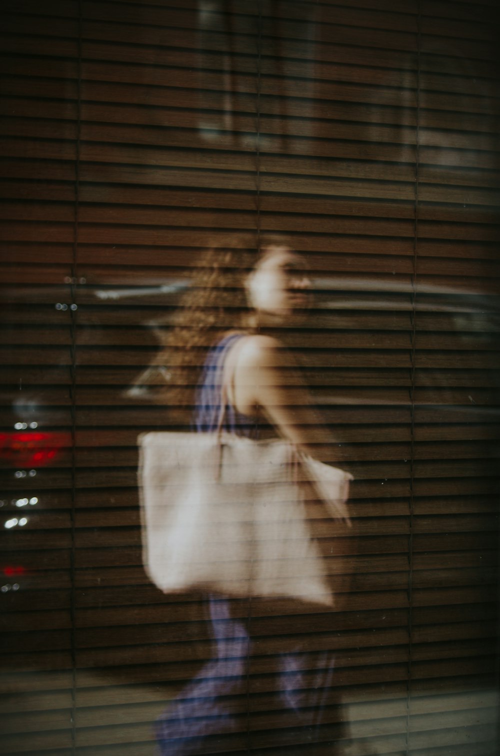 woman walking near glass wall