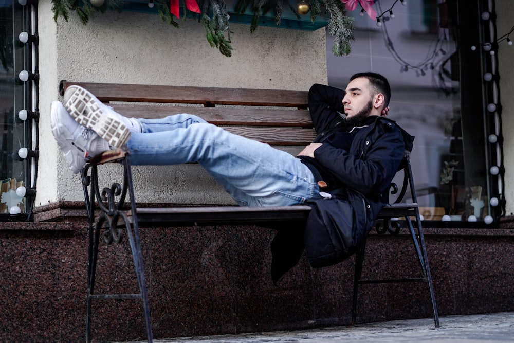 a man sitting on a bench with his feet up