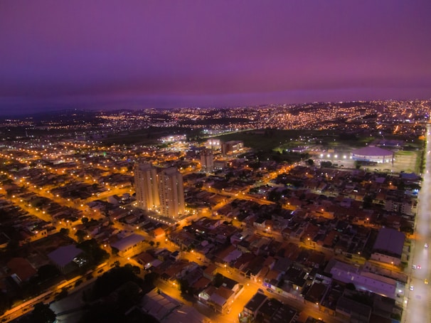 Aerial drone view of Paracatu’s cityscape at dusk with soft, cinematic lighting.