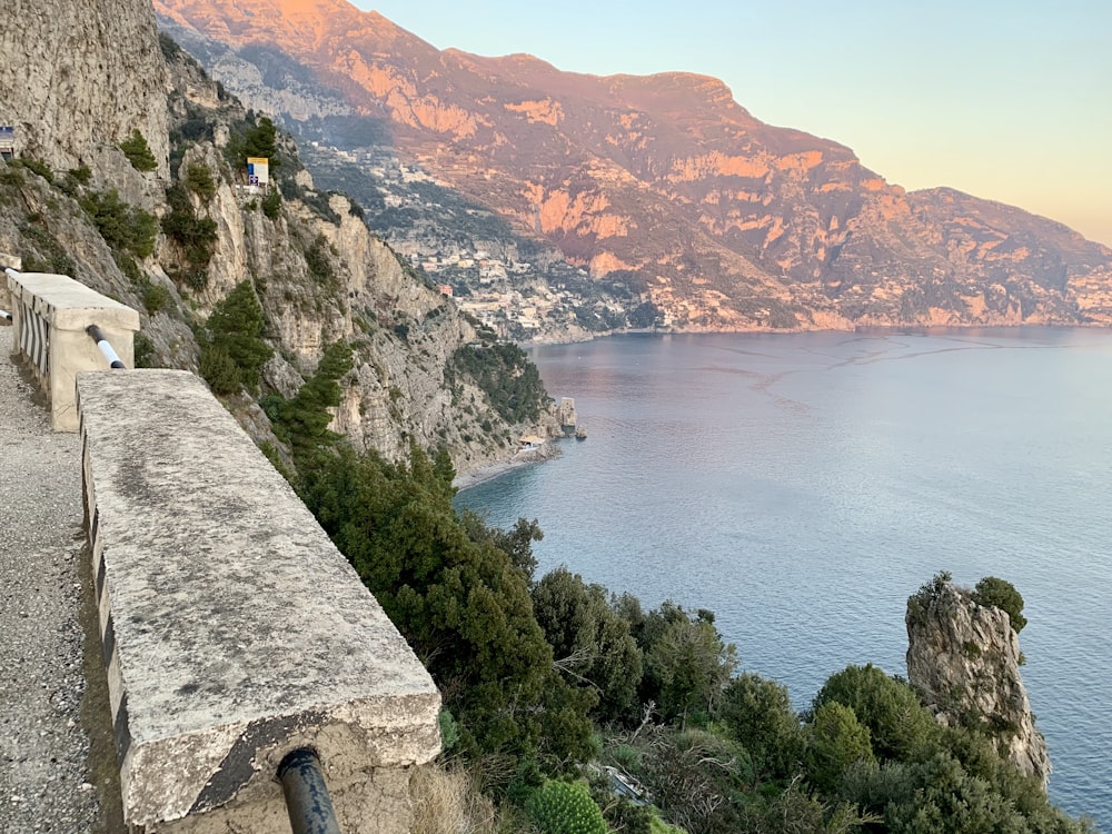 a scenic view of a body of water with mountains in the background