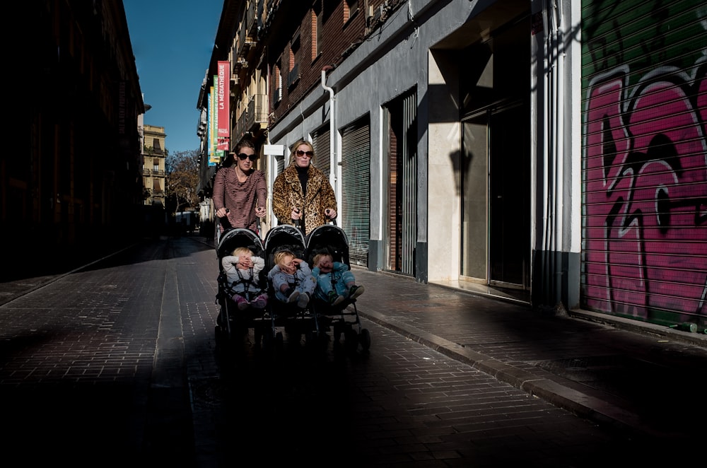 two women pushing stroller