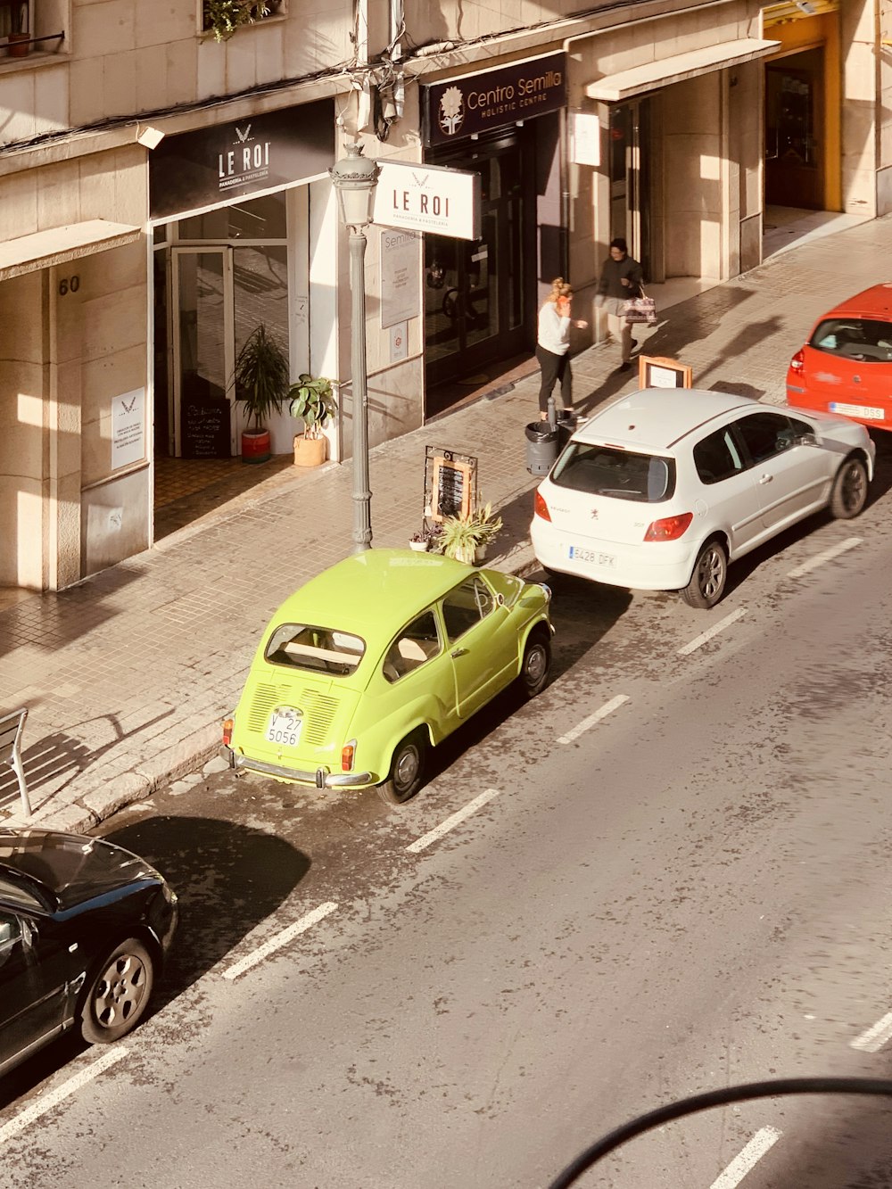 a couple of cars parked on the side of a street