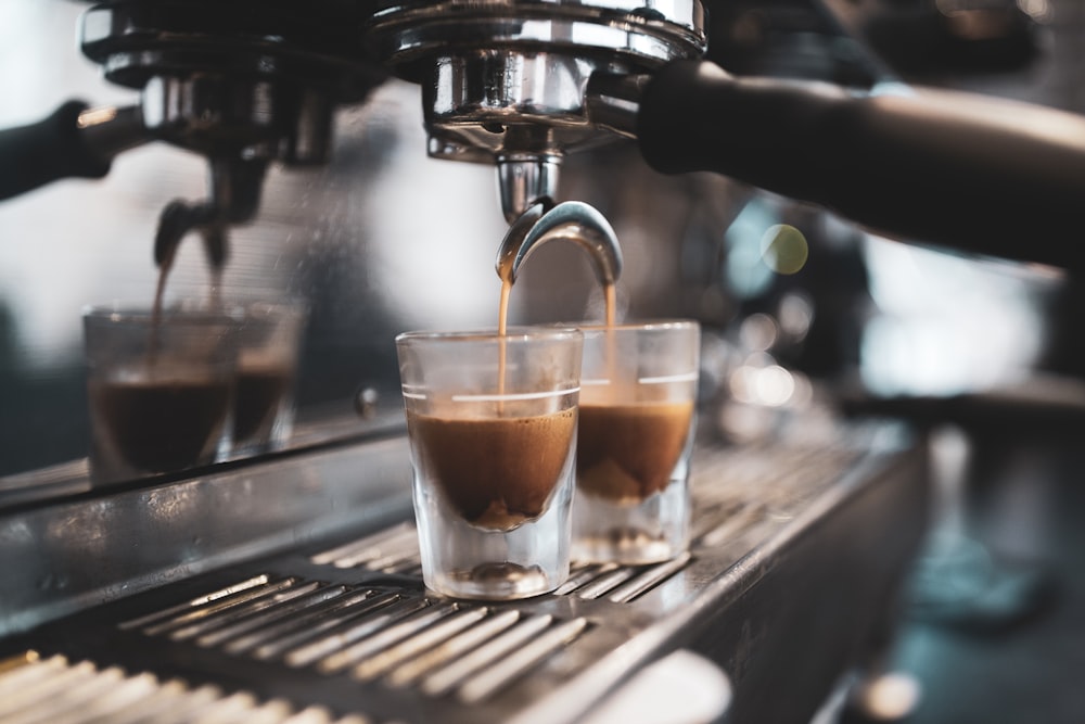 coffee pouring into two clear glasses