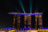 A panoramic view of the 12 residential towers illuminated at dusk, highlighting their sleek modern design.