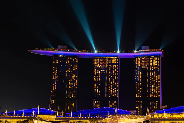 A panoramic view of the 12 residential towers illuminated at dusk, highlighting their sleek modern design.