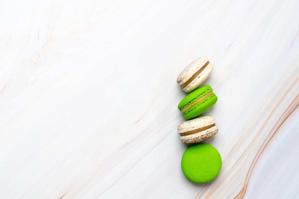 two green and two brown macarons
