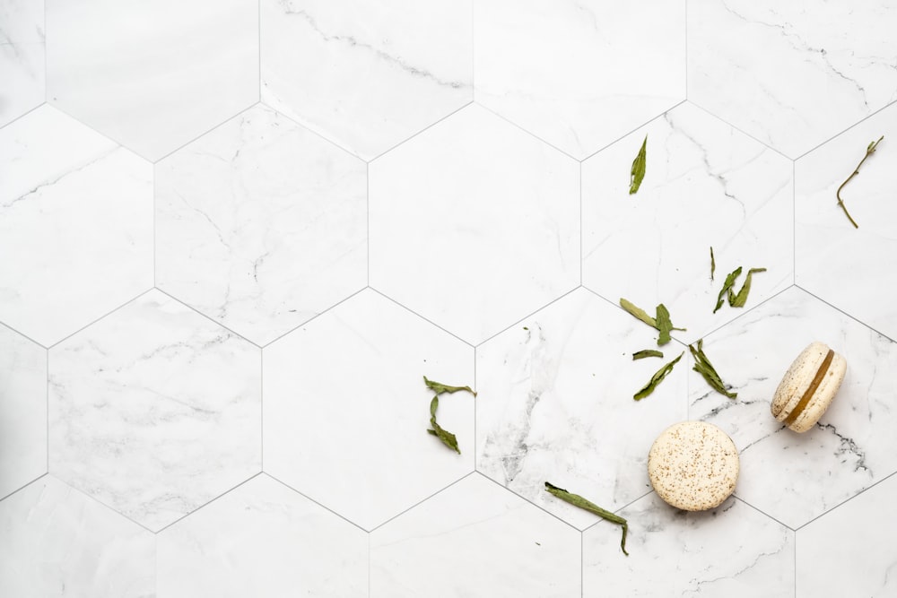 two round pastries on white tile floor