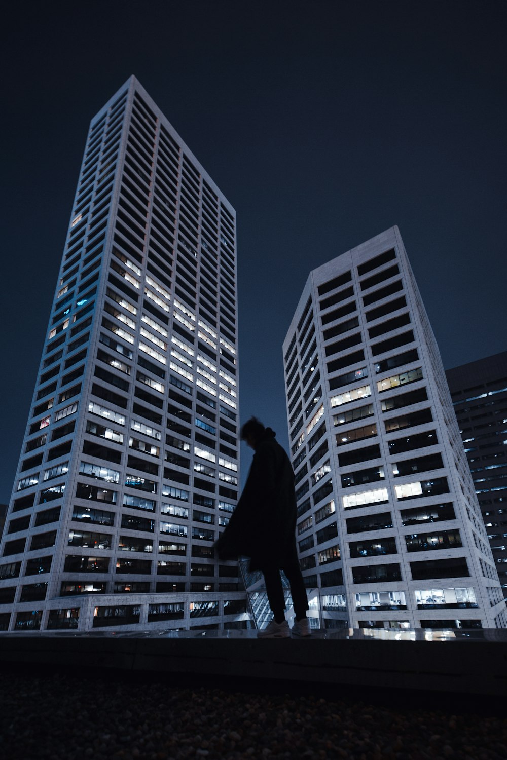 man in black jacket and pants standing on the building during daytime