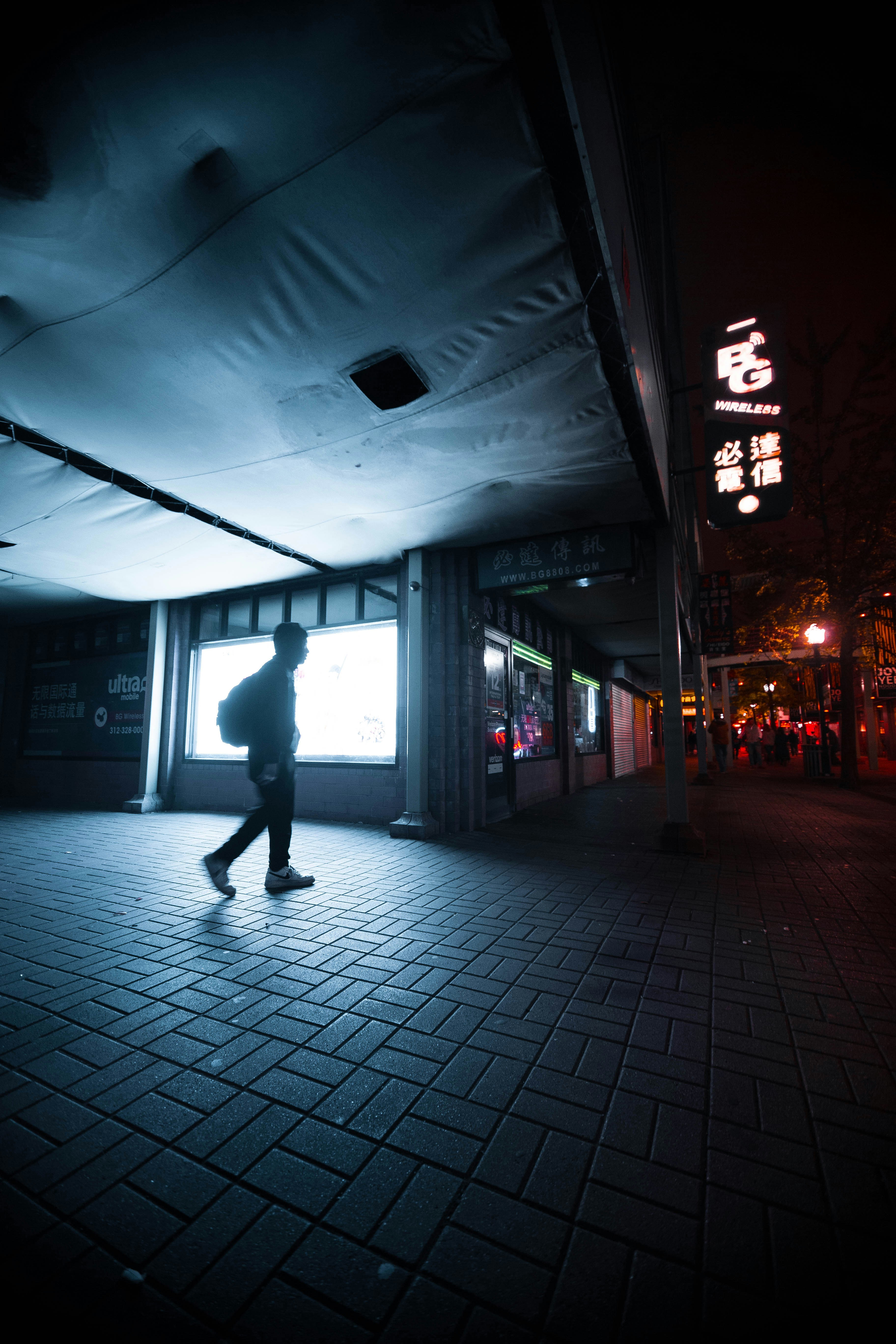 person walking beside building