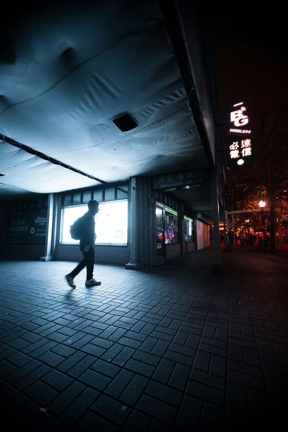 person walking beside building