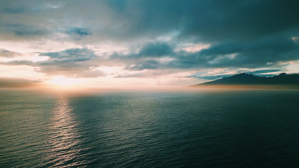 ocean under cloudy sky