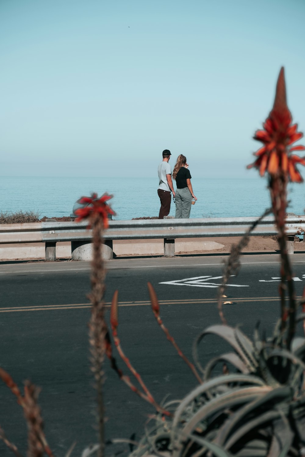shallow focus photo of man and woman in front of body of water