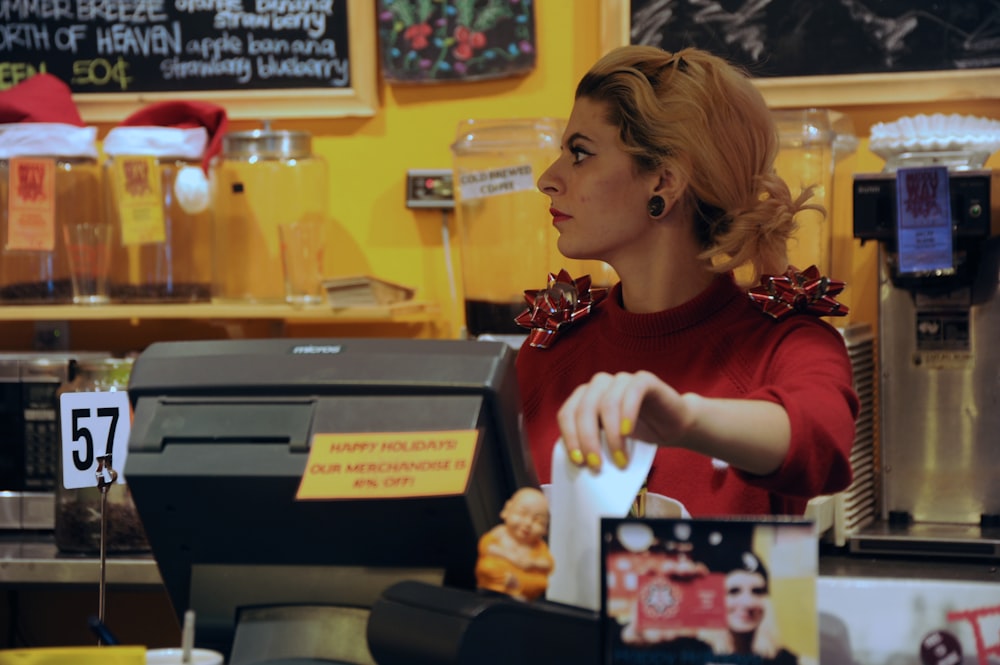 shallow focus photo of woman in red long-sleeved shirt