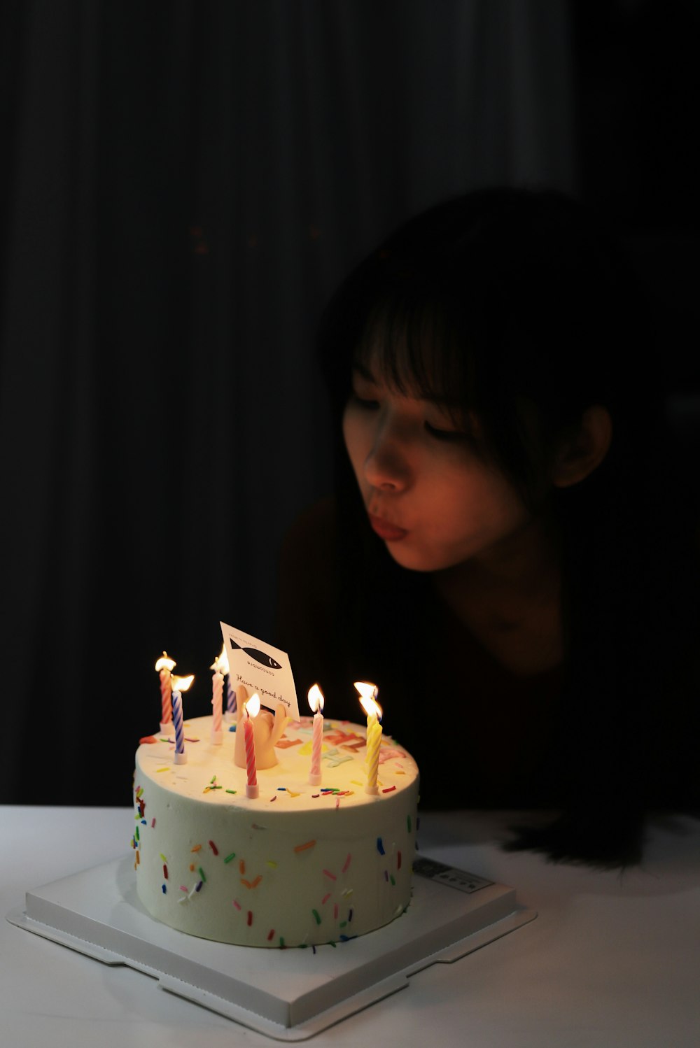 woman blowing candles on cake