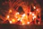 Close-up of intricate candle installations with soft glowing lights illuminating the night.
