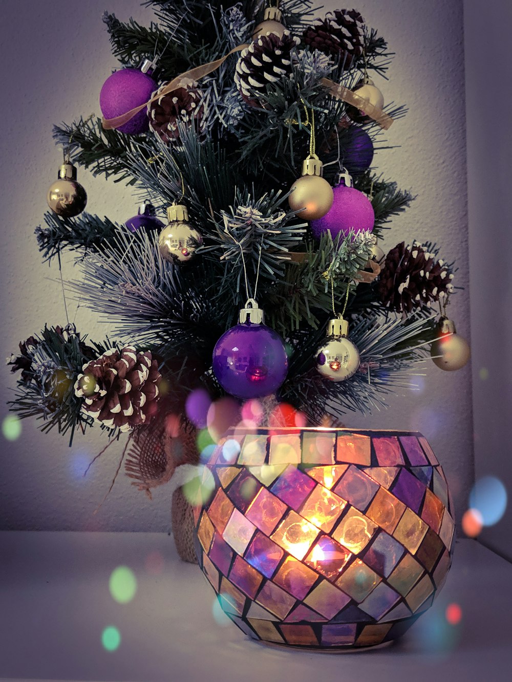 shallow focus photo of green holiday tree with purple baubles