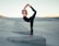 shallow focus photo of woman in black sleeveless shirt doing yoga