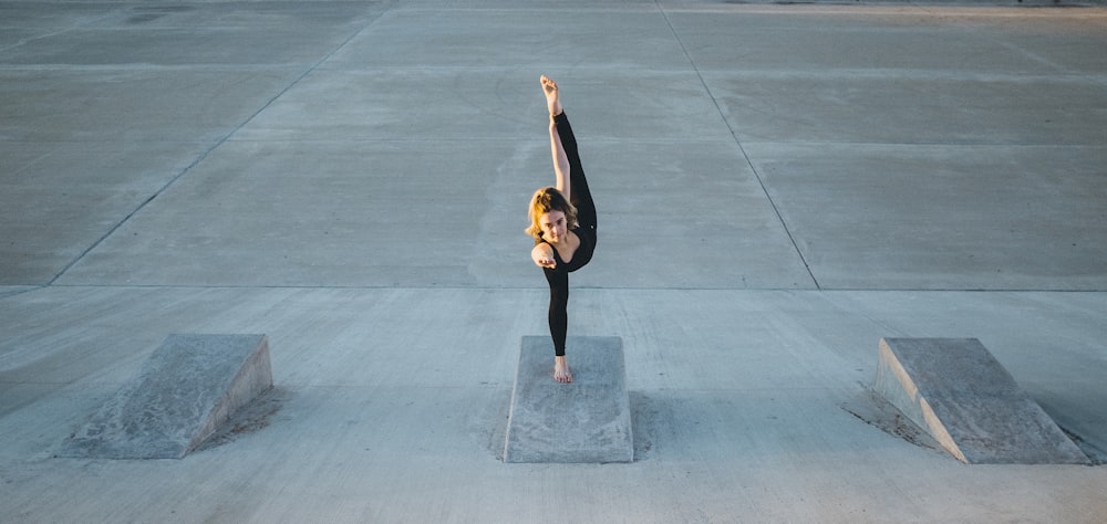 woman in black sleeveless shirt doing yoga