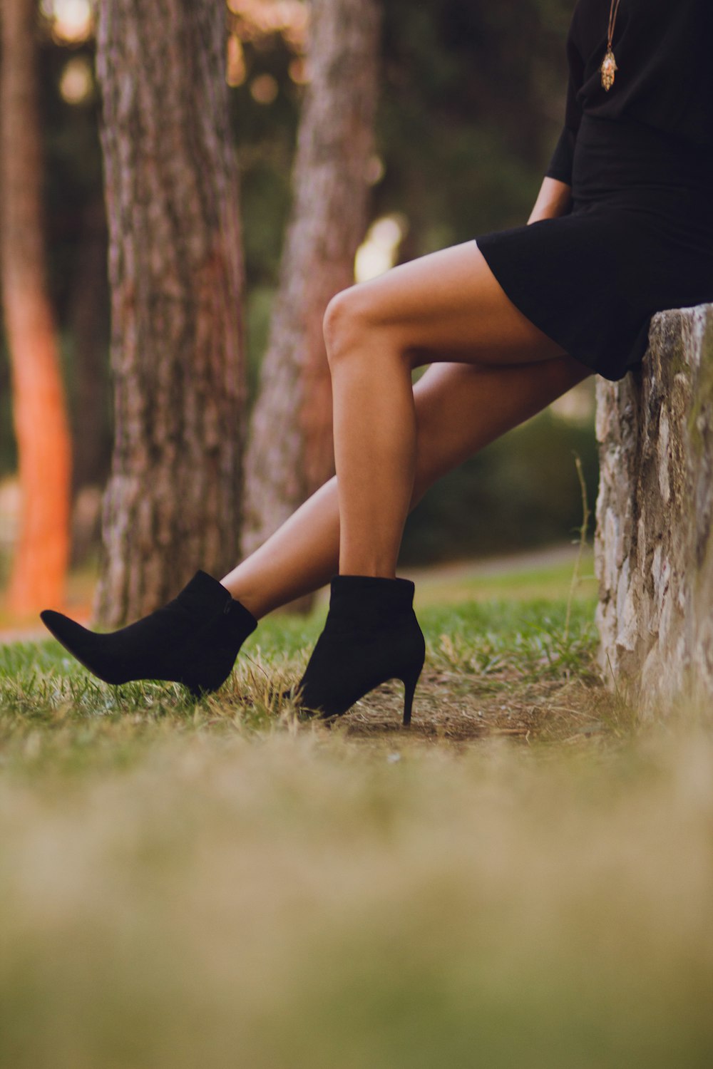 shallow focus photo of person in black booties