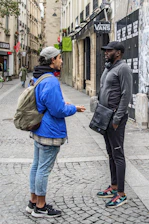 A journalist interviewing a local community member in an urban setting.