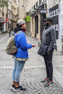 A journalist interviewing a local community member in an urban setting.
