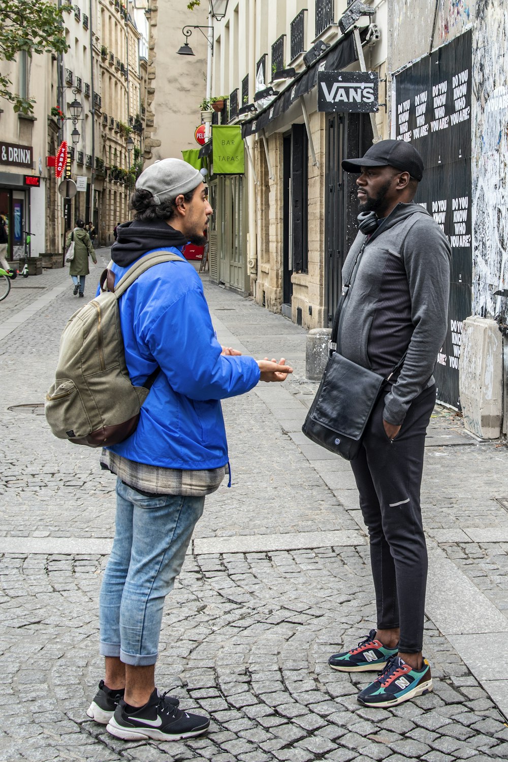 two person standing near building