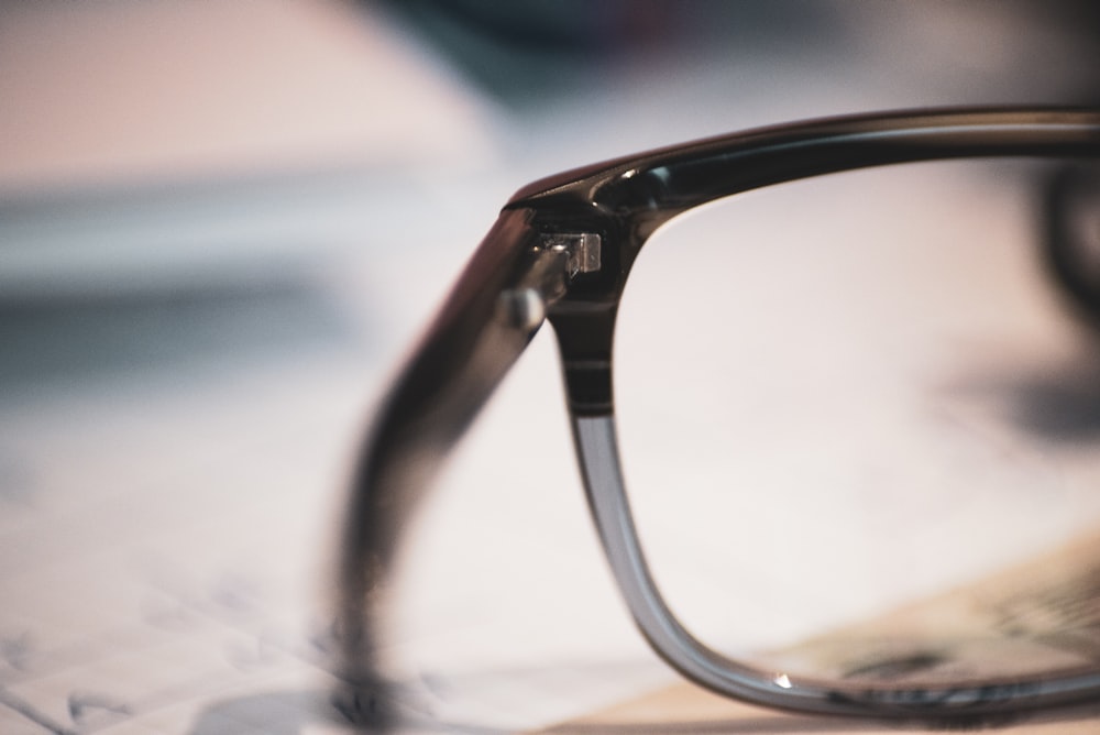 black-framed eyeglasses on gray surface