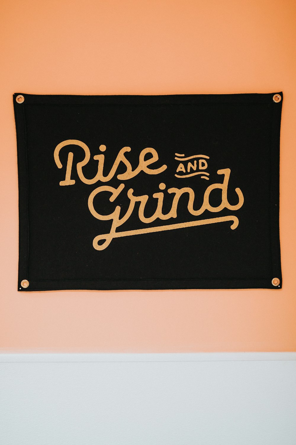black rise and grind wall decor mounted on brown wall