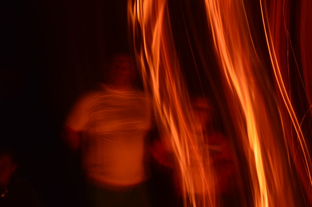 two persons stands behind bonfire