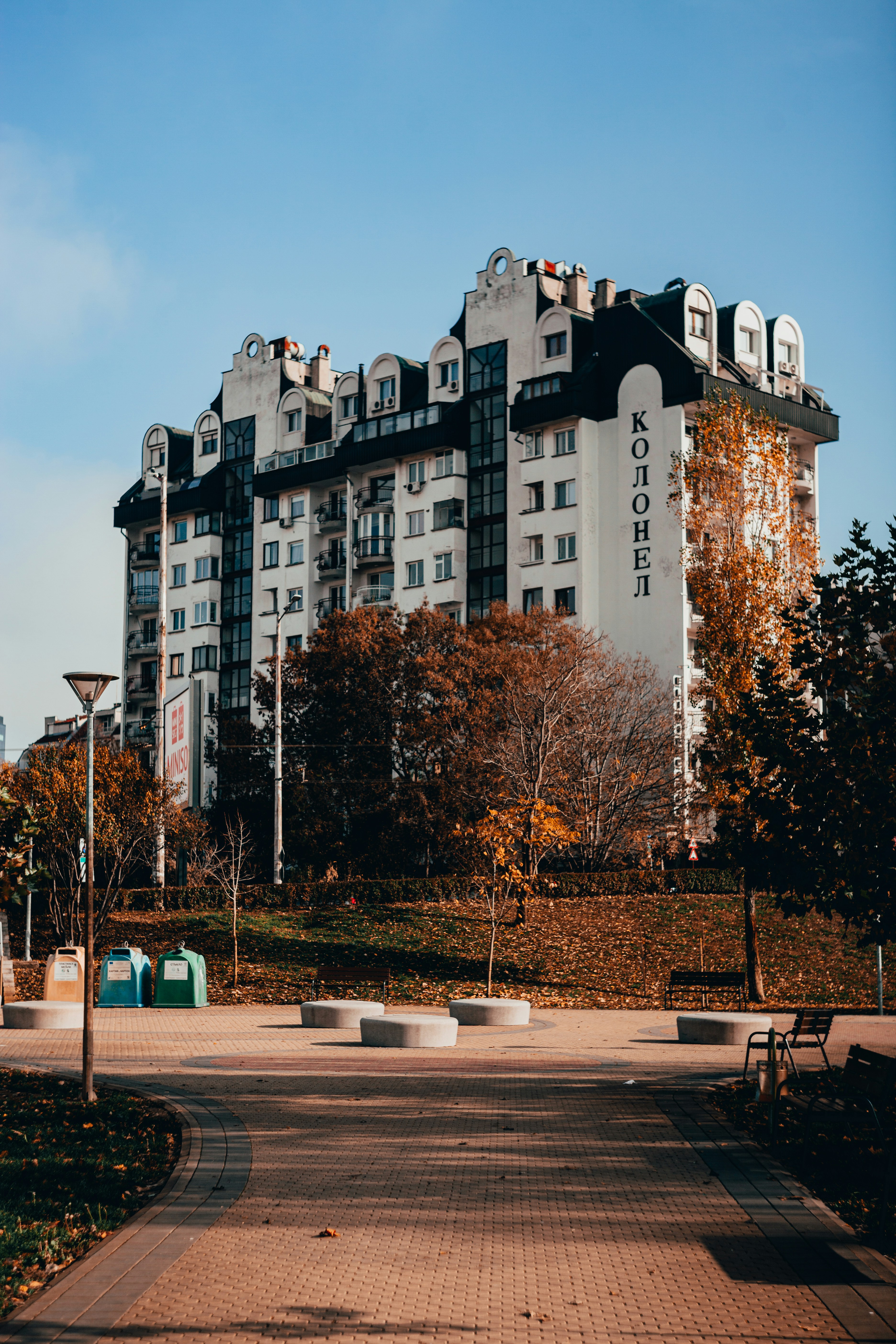 white and black concrete building near trees