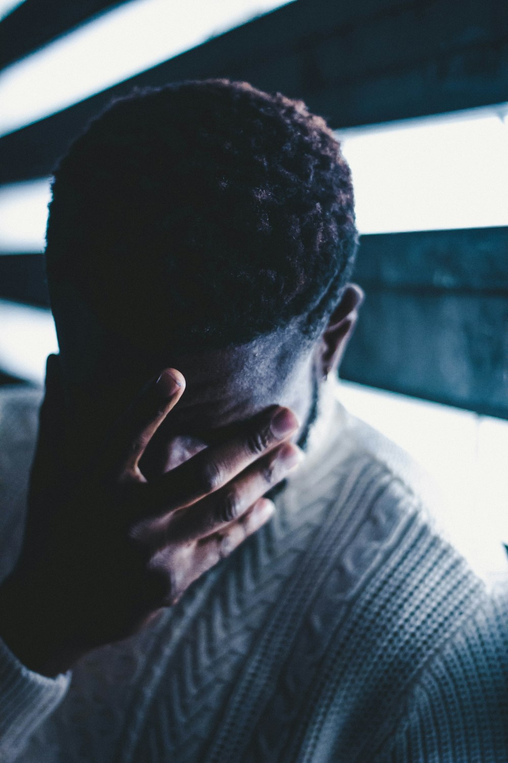 man standing near grey wall