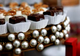 Elegant display of assorted chocolates on ivory silk fabric.