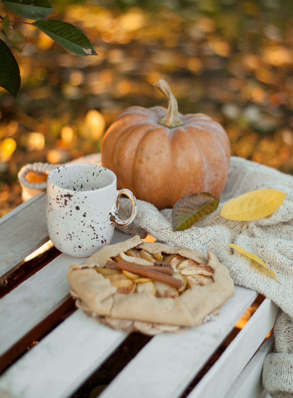 white ceramic mug beside squash