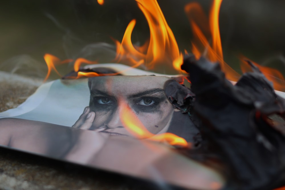 burning photo of person