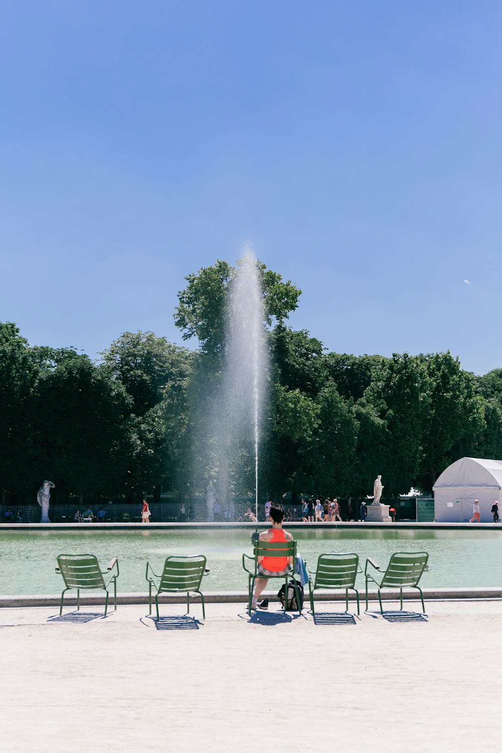 person sitting beside pool