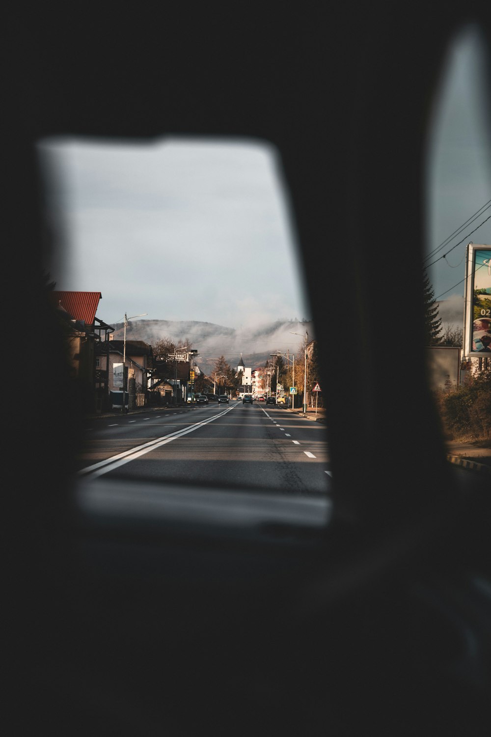 a view of a street from inside a vehicle