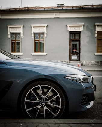 A sleek used car parked on a city street, showcasing its elegant design.