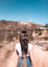 woman in white top standing beside road symbolising video production company los angeles