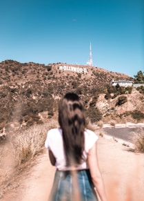 woman in white top standing beside road symbolising video production company los angeles