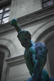 A heroic figure holding a glowing dumbbell with epic, ancient Greek-inspired armor elements.