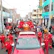 coffin on red truck beside men in red uniform