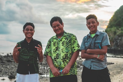 three person standing on beach samoa teams background