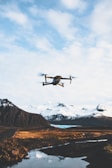 An advanced drone flying over a scenic landscape.