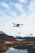 A satisfied customer flying a Skypulse drone in a scenic landscape.