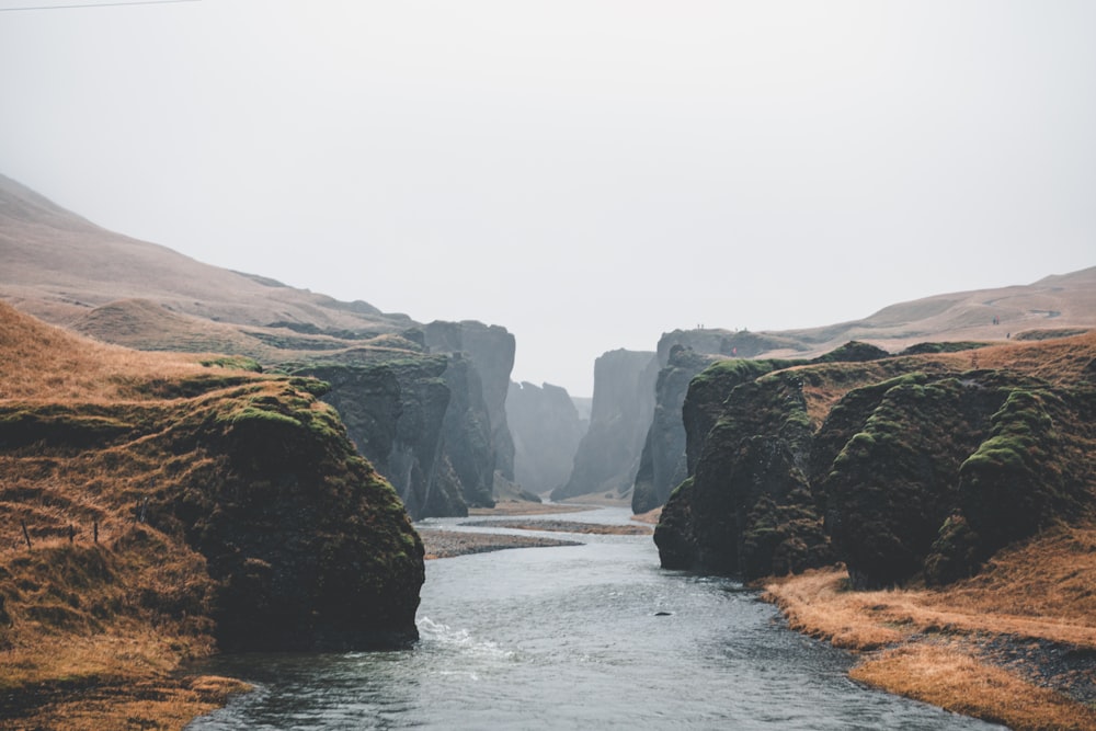 view of river between cliffs under clear sky