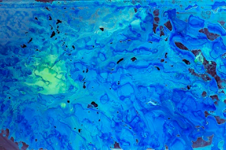 Close-up of a textured canvas showing swirling blues and greens from the 'Uncharted Horizons' collection.